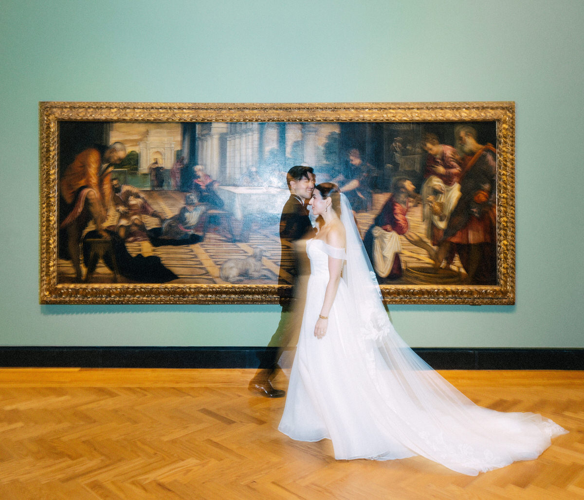 wedding couple walking past a large European painting at the AGO