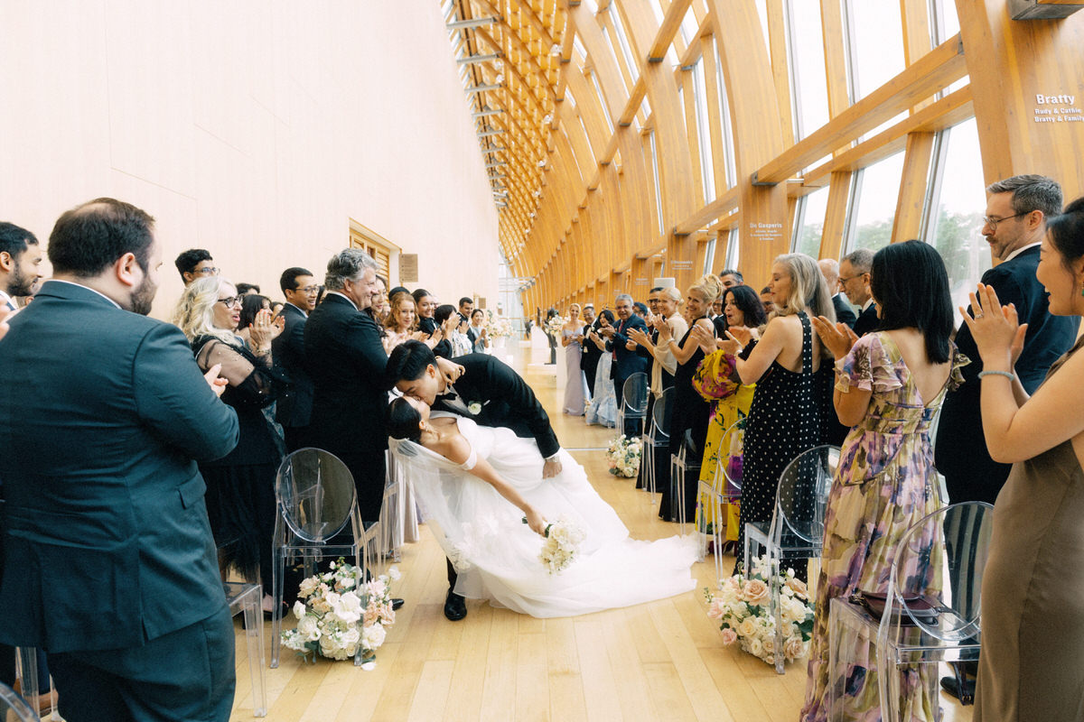 groom dipping bride for a kiss inside Galleria Italia at the AGO