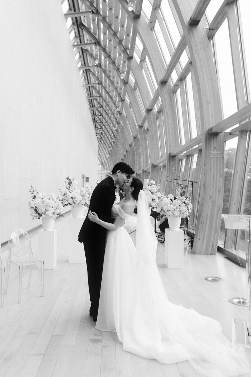 wedding couple kissing at a wedding ceremony inside Galleria Italia at the AGO