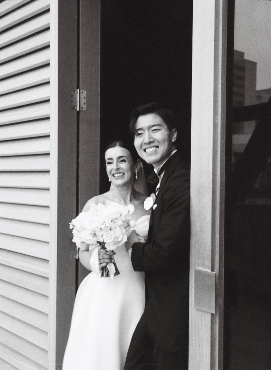 classic 35mm film photo of a wedding couple smiling at their guests