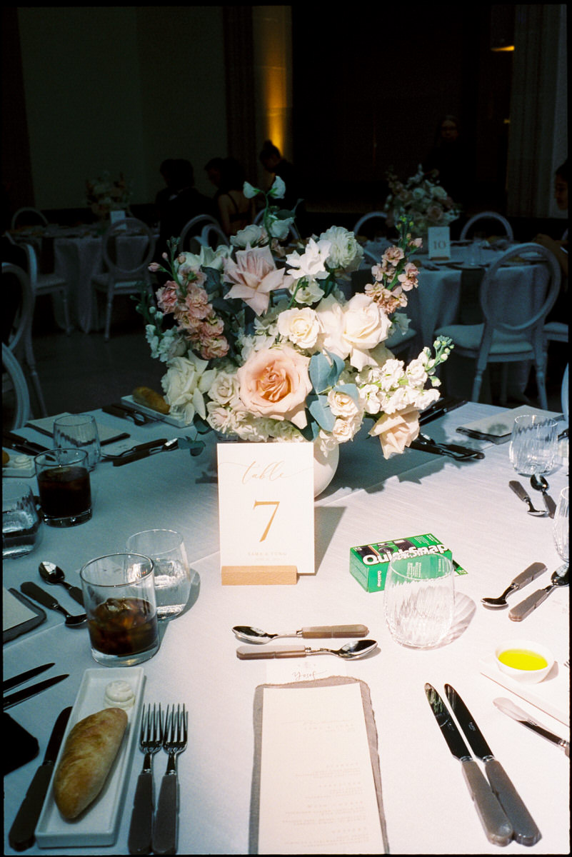 35mm photo of a beautiful floral centrepiece and a single use film camera