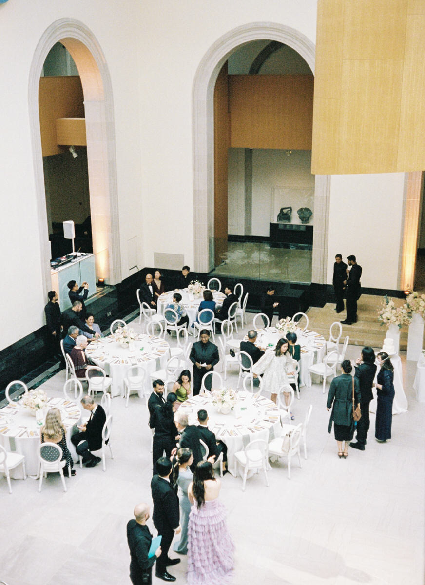 wedding guests finding their seats inside Walker Court at the Art Gallery of Ontario