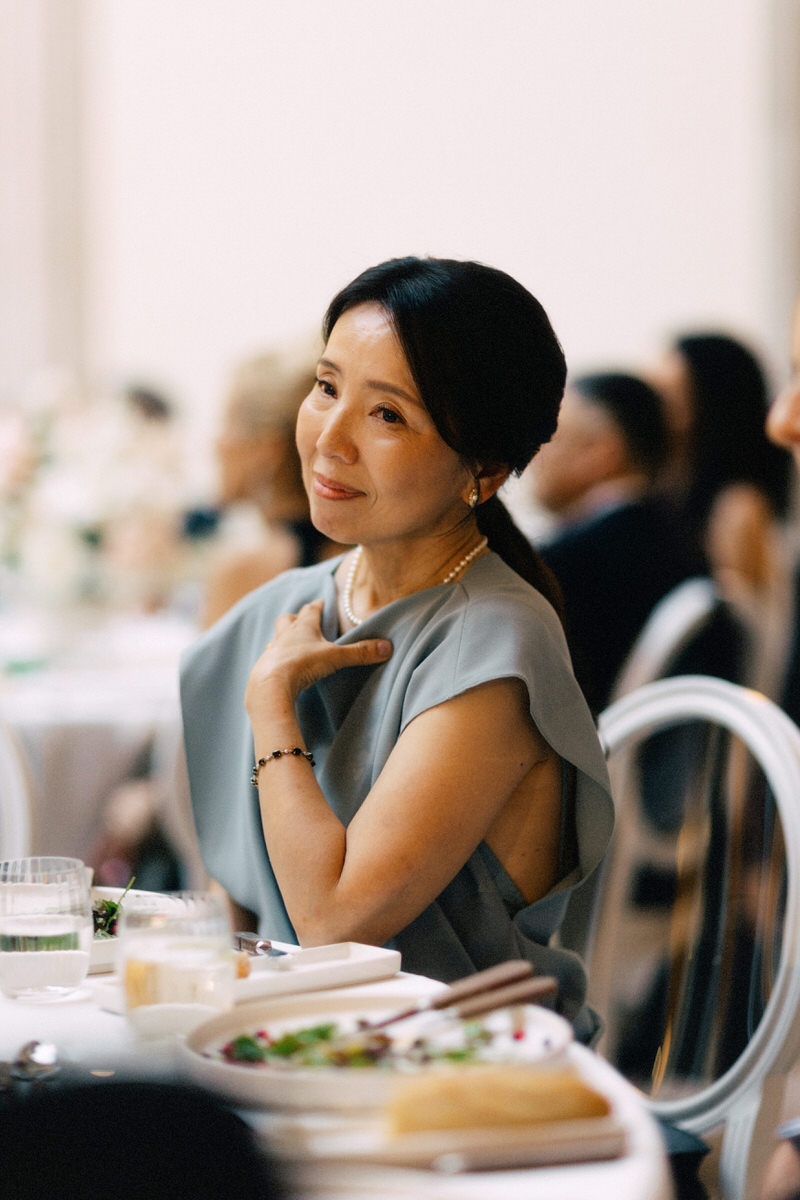 candid portrait of a proud and emotional Asian mother during a wedding reception in Toronto