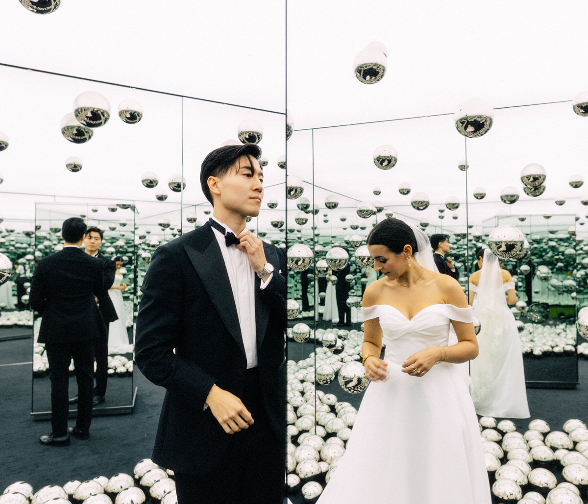 portrait of bride and groom inside Yayoi Kusama mirrored infinity room at the AGO Art Gallery of Ontario