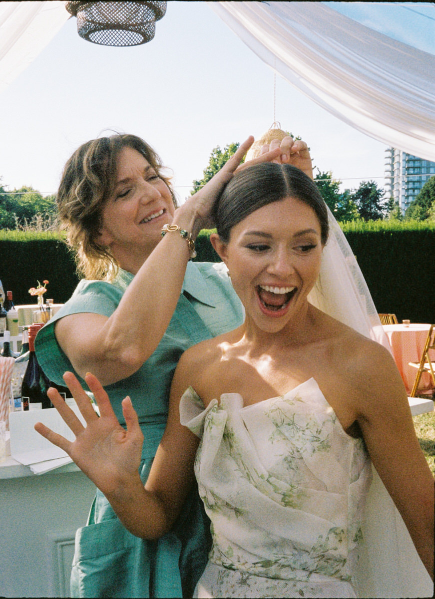 35mm film photo of a mother helping her daughter reattach her veil