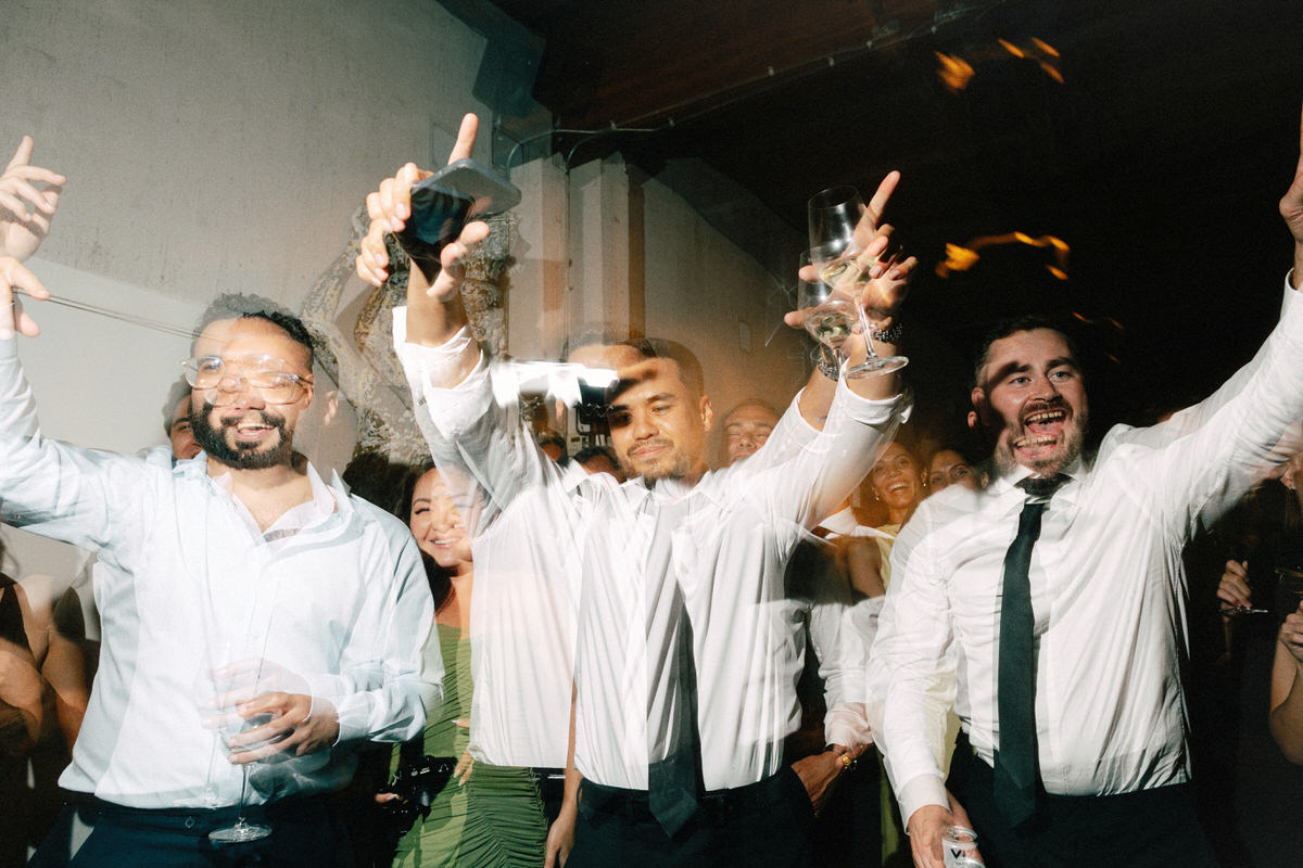 wedding guests enjoying themselves on the dance floor. multiple exposures are used to enhance these fun and energetic moments