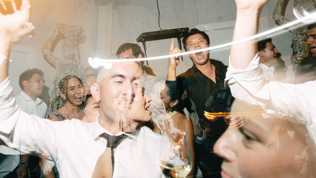 wedding guests enjoying themselves on the dance floor. multiple exposures are used to enhance these fun and energetic moments