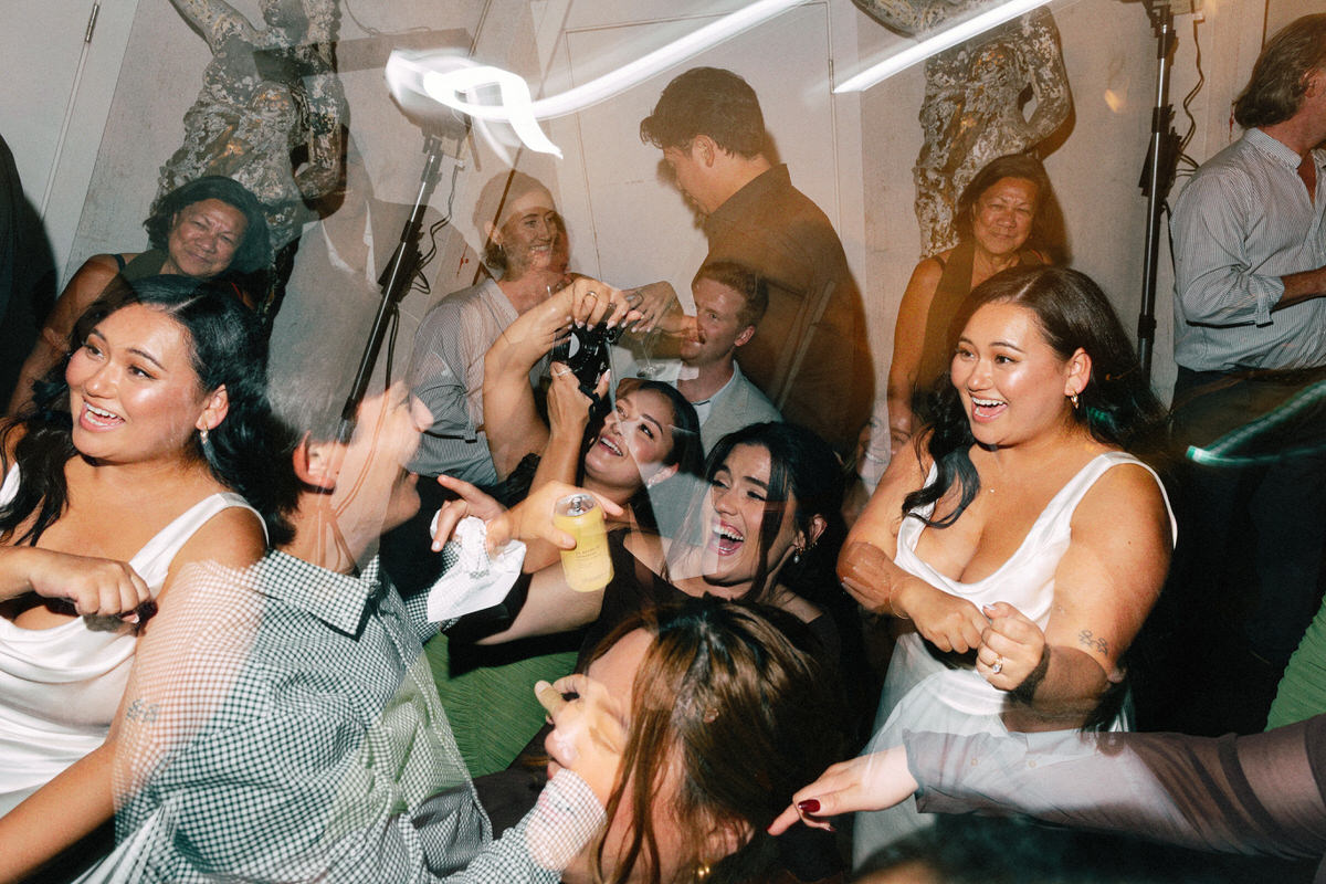 wedding guests enjoying themselves on the dance floor. multiple exposures are used to enhance these fun and energetic moments