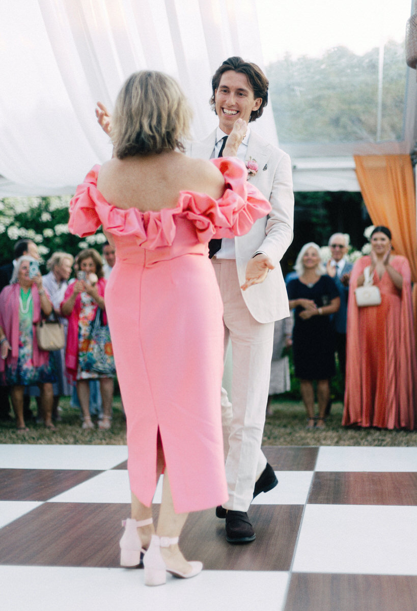 groom going in to hug his mother after first dances at his UBC Botanical Garden wedding