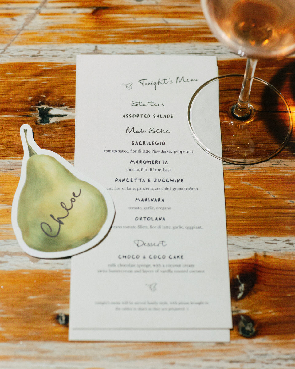 italian inspired dinner menu for a wedding reception at la fabrique st george winery, stylized with an illustrated pear name tag and wine glass