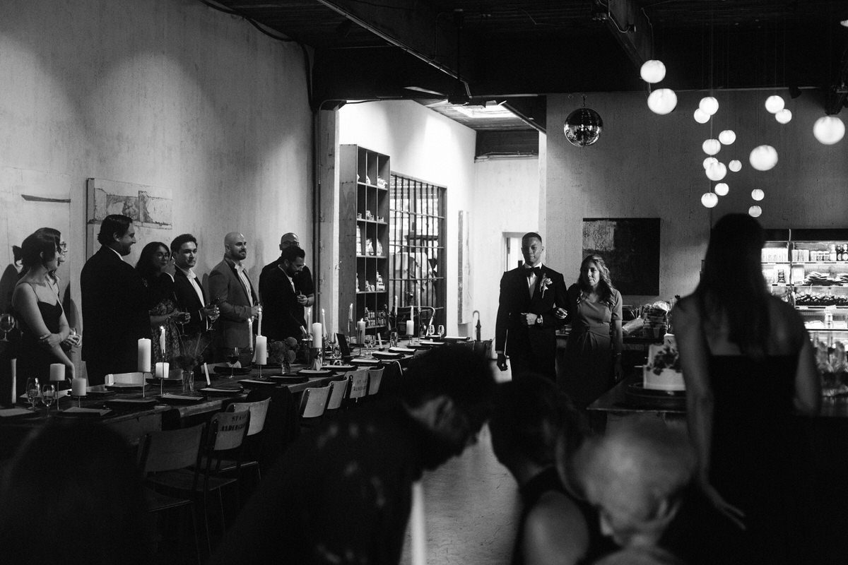 hispanic mother walking into the event space at la fabrique st george with her biracial son on his wedding day