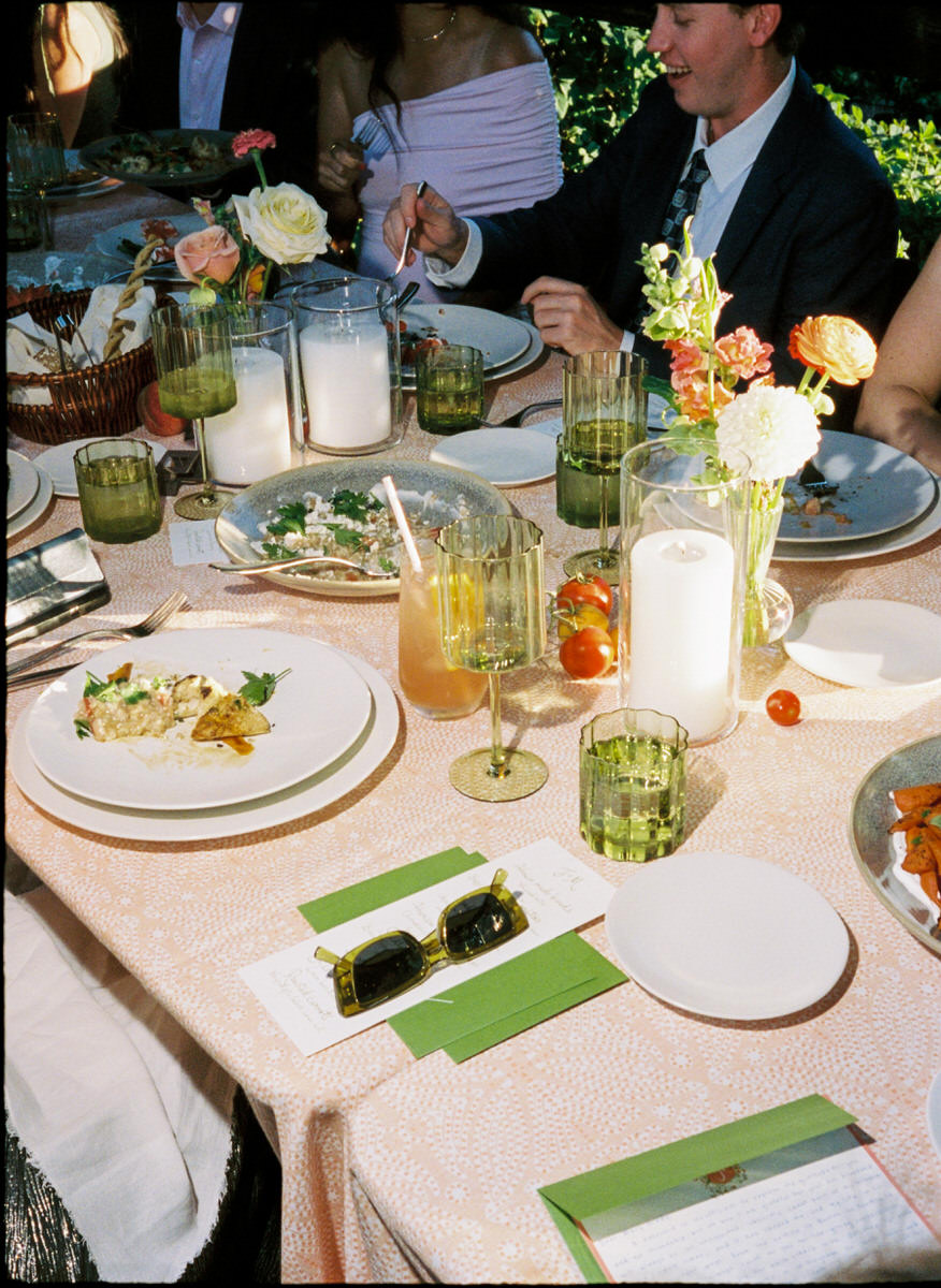 35mm film photo of wedding guests eating dinner under the arbour at UBC Botanical Garden