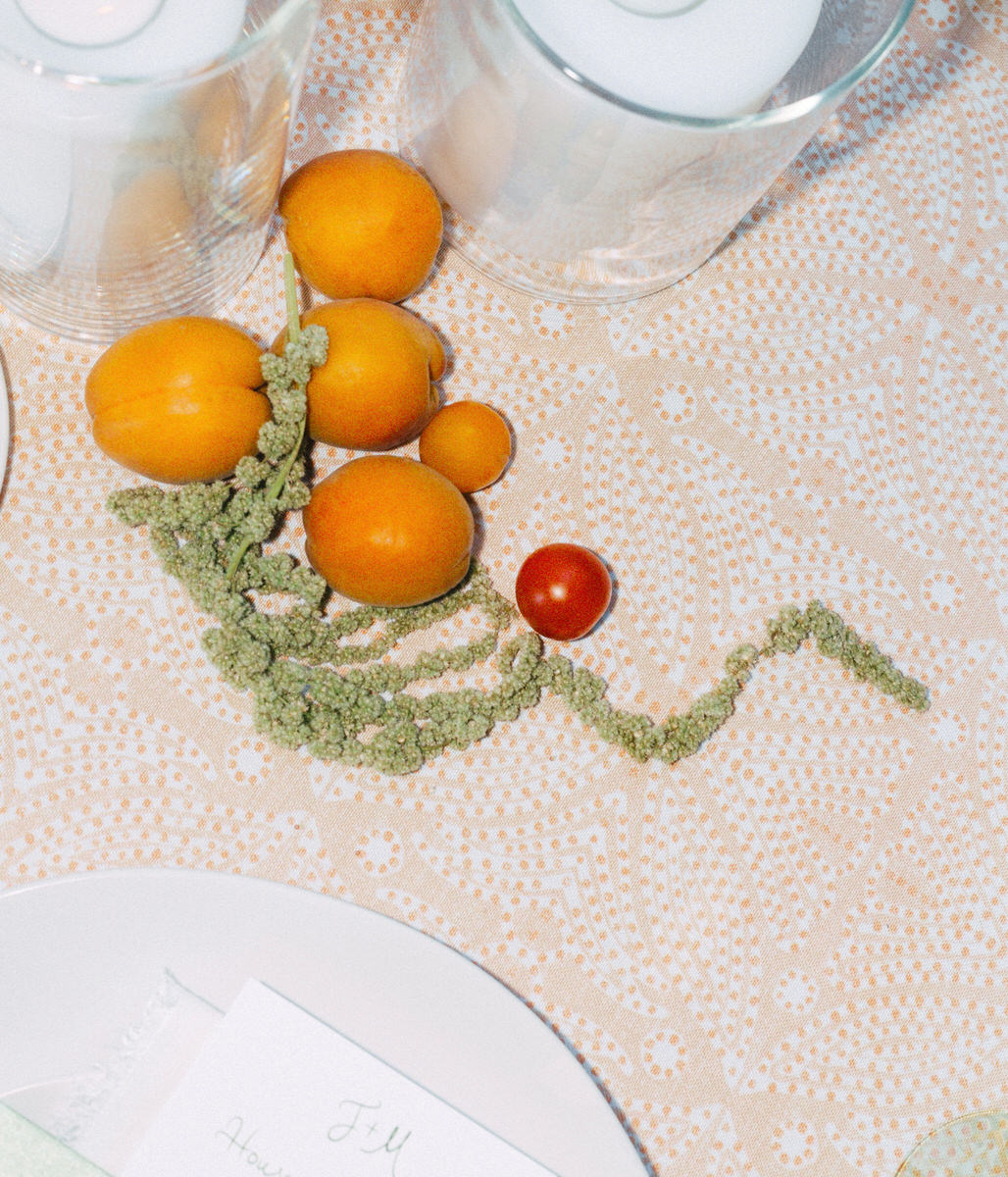 apricots, cherry tomatoes, and green amaranth as garden party table settings at a UBC Botanical Garden wedding