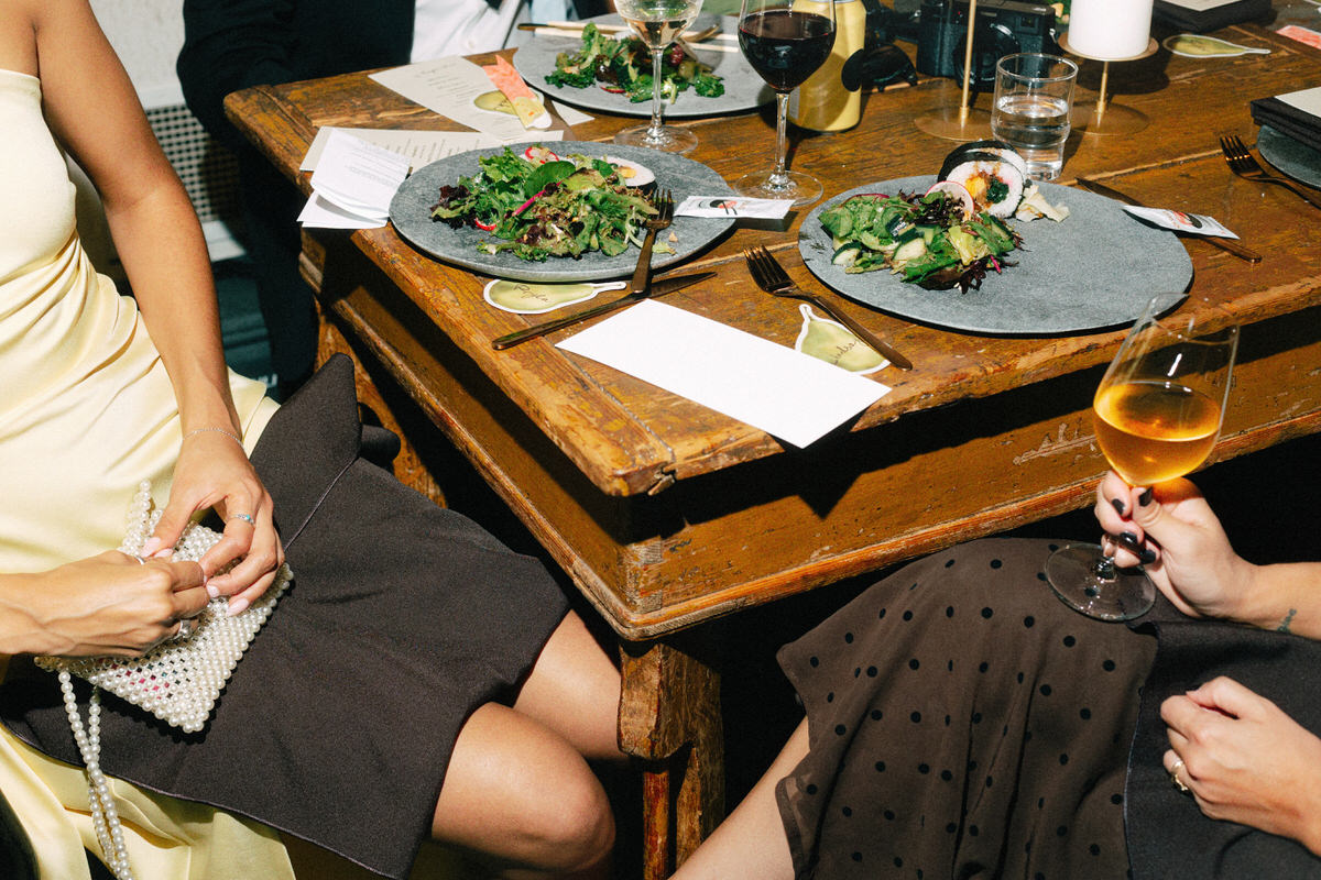 direct flash photo of wedding guests enjoying dinner at la fabrique st george winery in vancouver