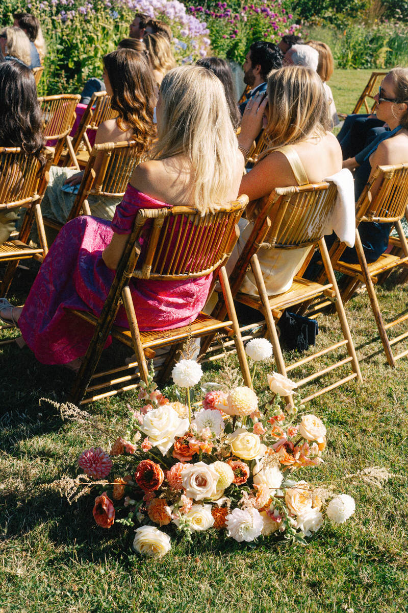 citrus coloured floral arrangement at a UBC Botanical Garden wedding ceremony