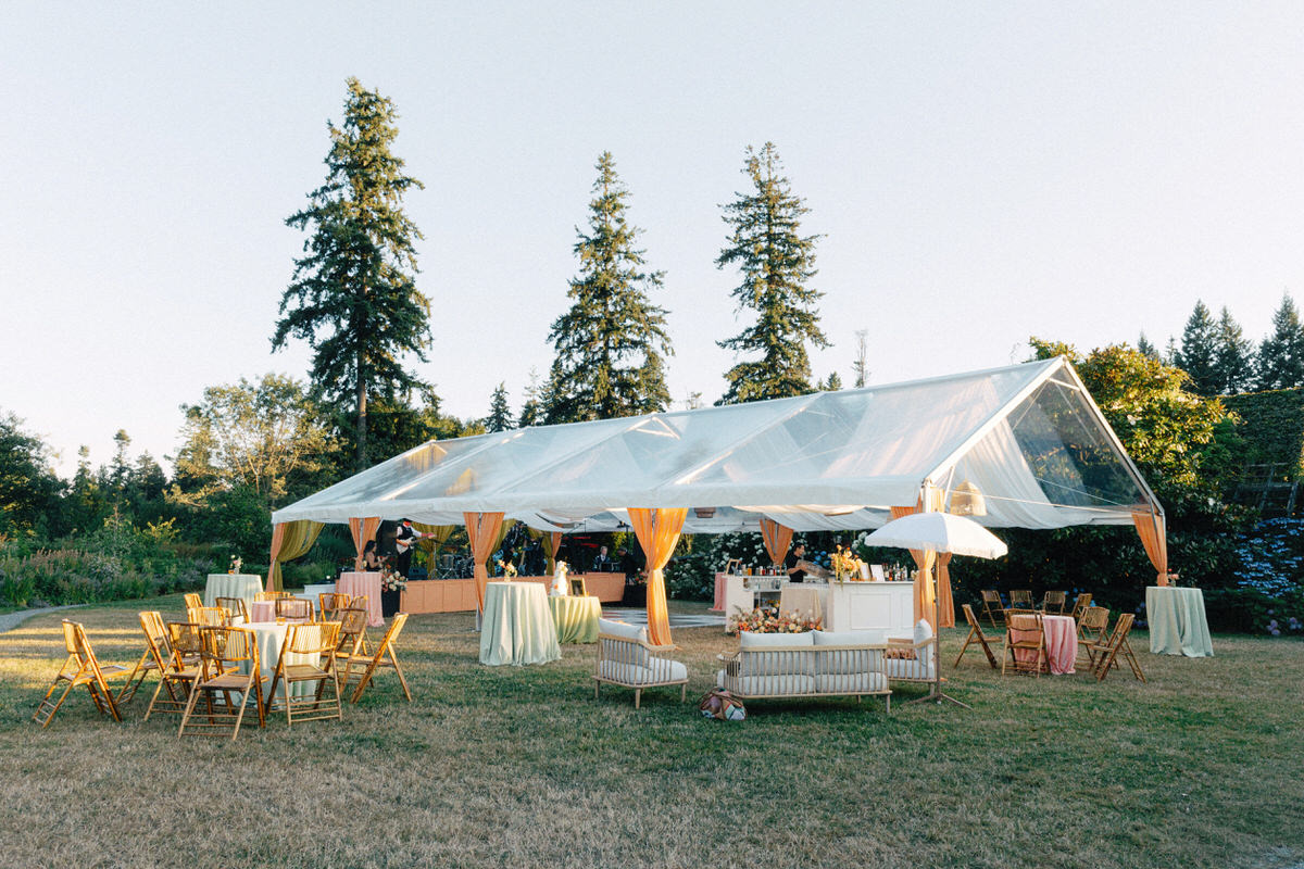 tented wedding reception setup at UBC Botanical Garden during golden hour