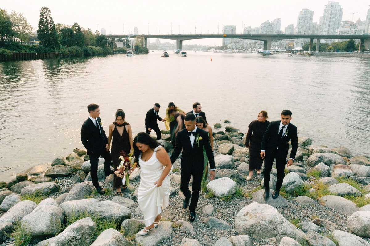 a wedding party walking away from a photo spot at habitat island in olympic village vancouver