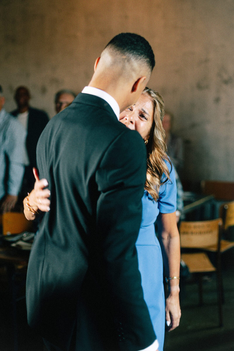 an emotional moment between a groom and his mother during a wedding ceremony at la fabrique st george