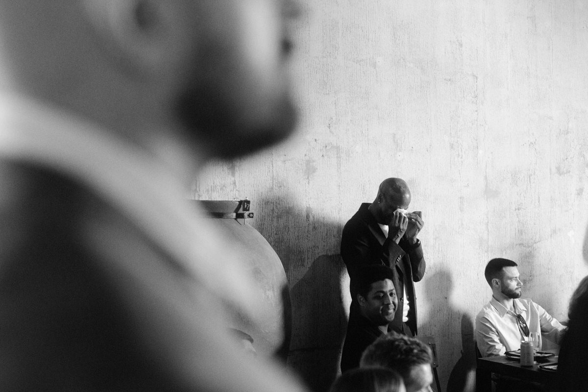 a father wiping away tears during his son's wedding ceremony at la fabrique st george in vancouver