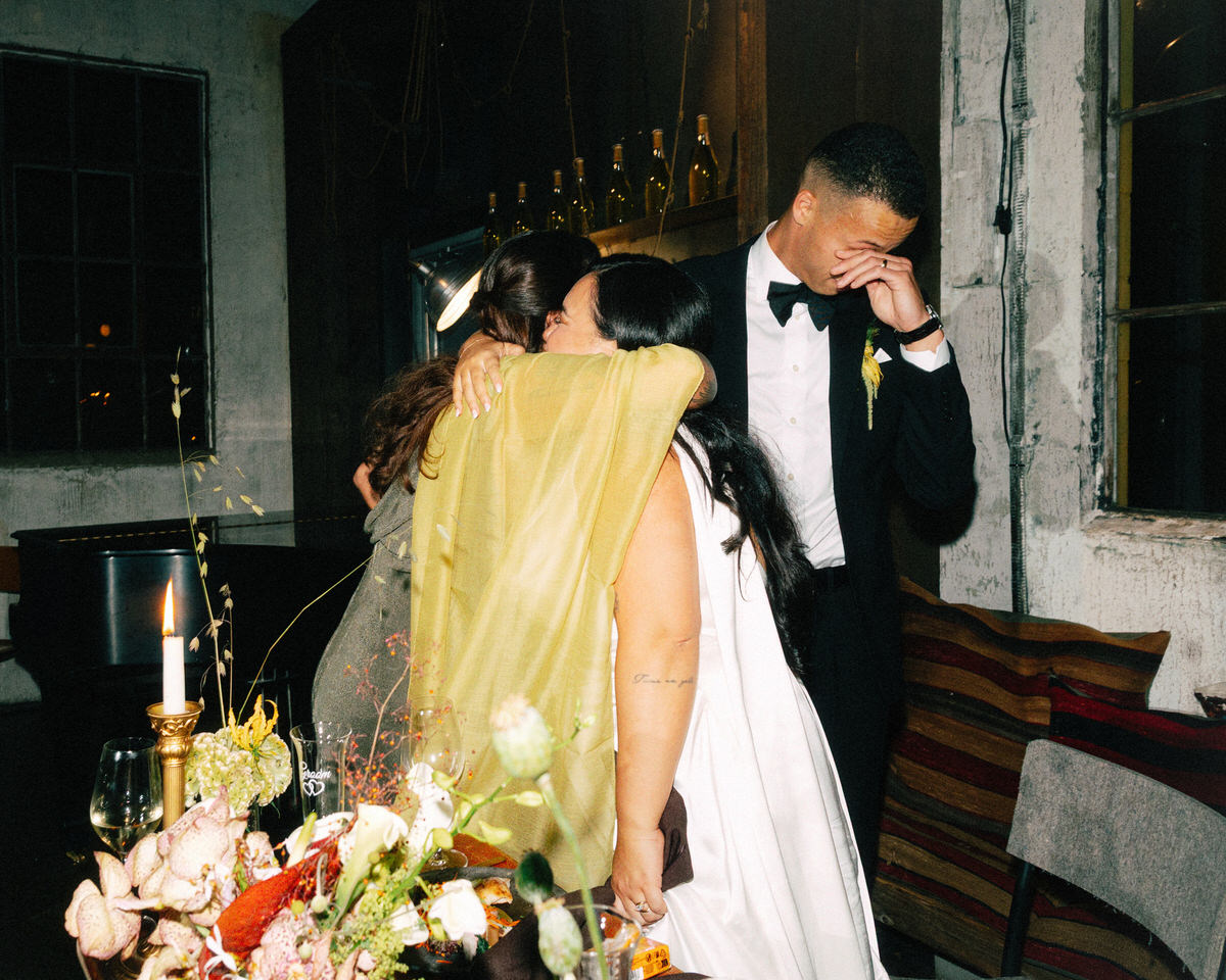 emotional moment between a bride, groom, and a bridesmaid during wedding speeches at la fabrique st george