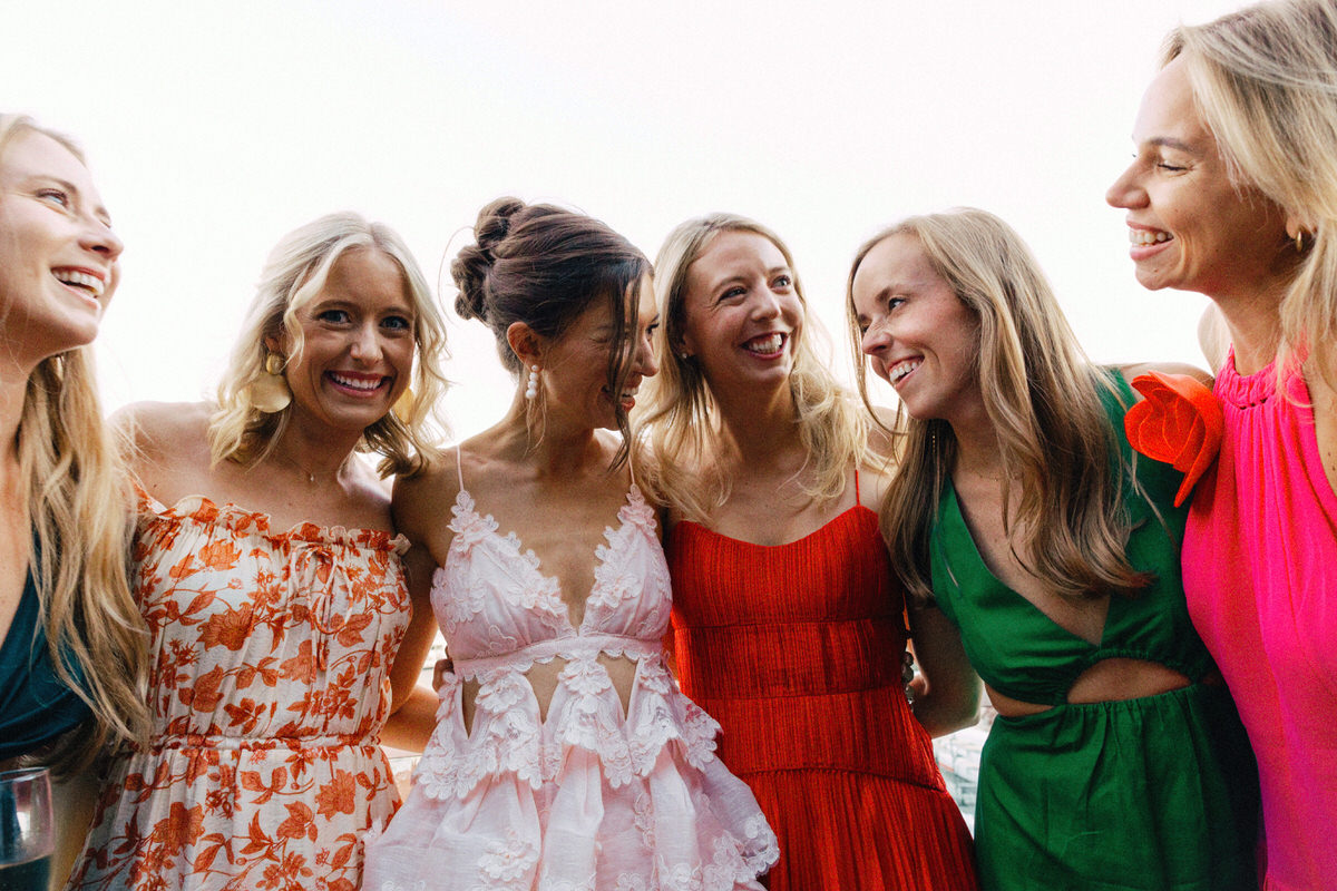 bride in Zimmermann crush lace maxi dress hugging fashionable wedding guests