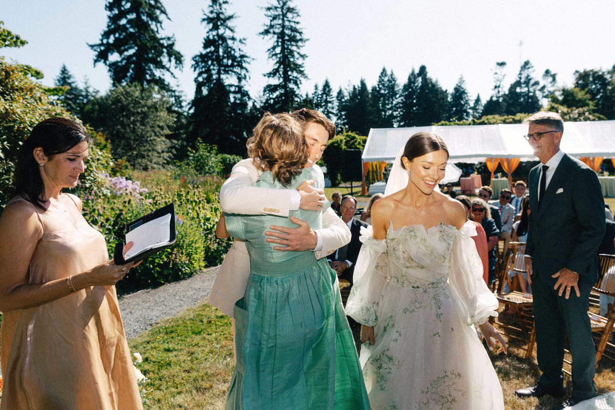 groom hugging mother during a ceremony at UBC Botanical Garden