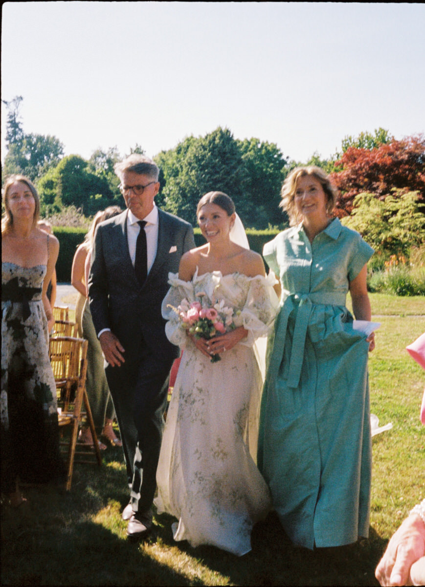 35mm film photo of bride walking down the aisle by her parents at UBC Botanical Garden