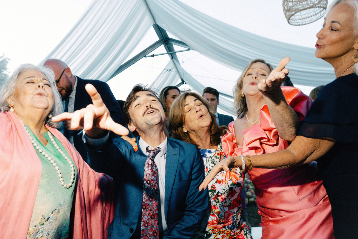 guests blowing kisses towards the camera at a UBC Botanical Garden wedding