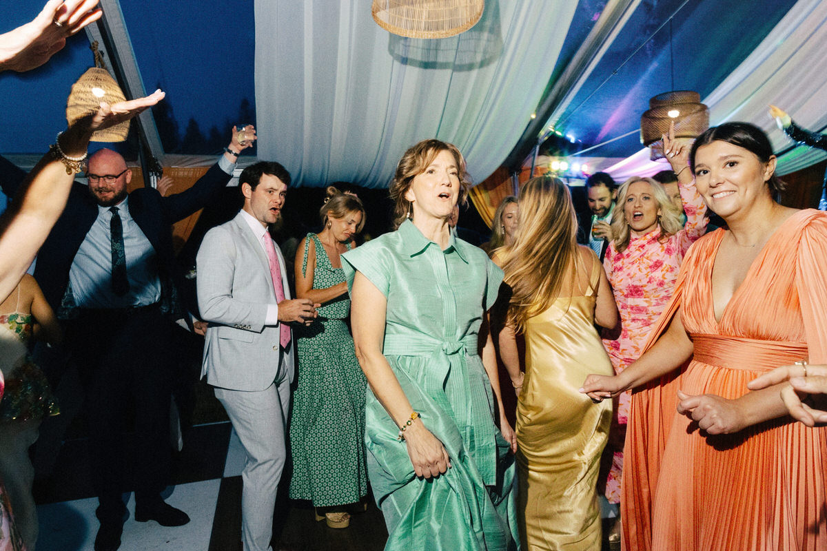 documentary style photo of guests dancing at a UBC Botanical Garden wedding reception featuring a rainbow spectrum of outfits