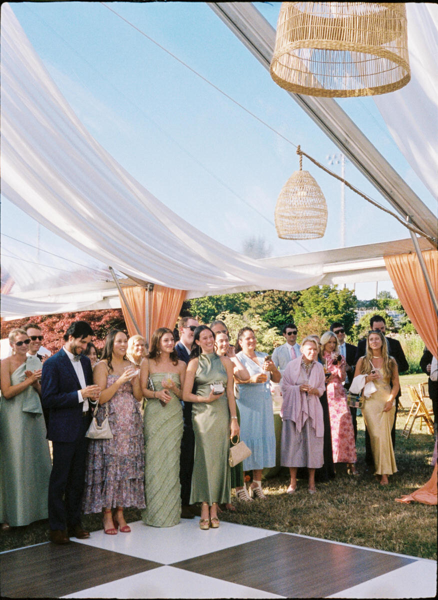 35mm photo of guests enjoying a tented wedding reception at the UBC Botanical Garden